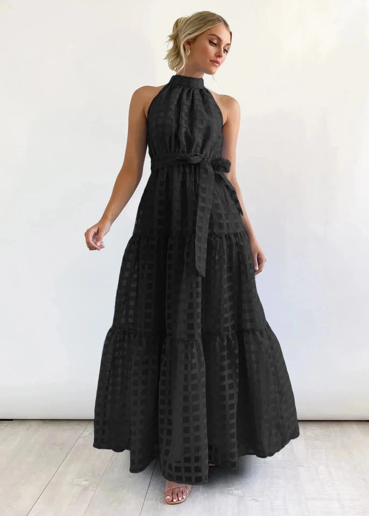 "Sleeveless black maxi dress with high neckline, made from soft and flowing fabric, perfect for a chic and elegant look."