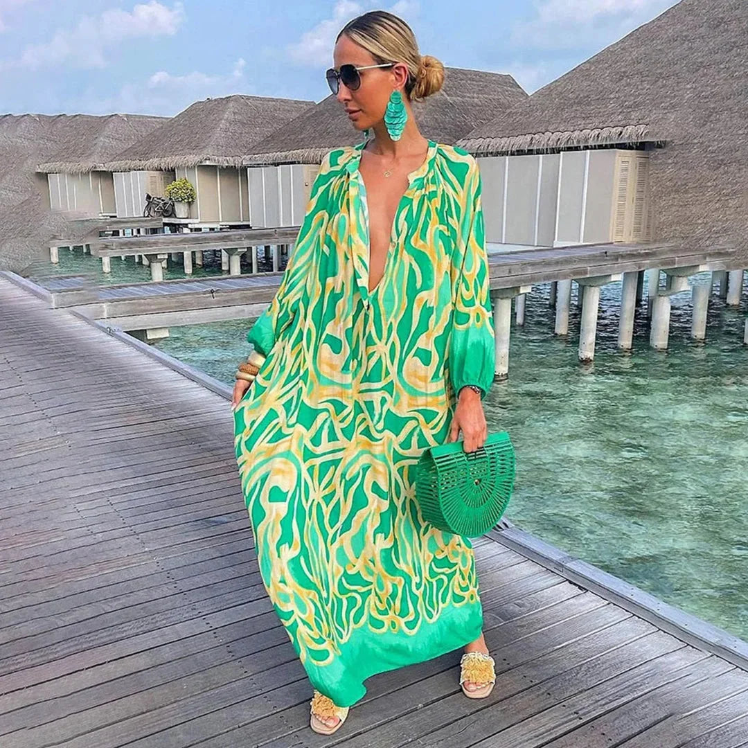 Green chiffon beach kaftan dress with breezy design, perfect for sunny days by the water.