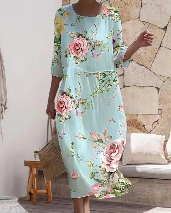 Pink floral midi dress with sleeves, perfect for the beach. Light and airy fabric with a flattering fit.