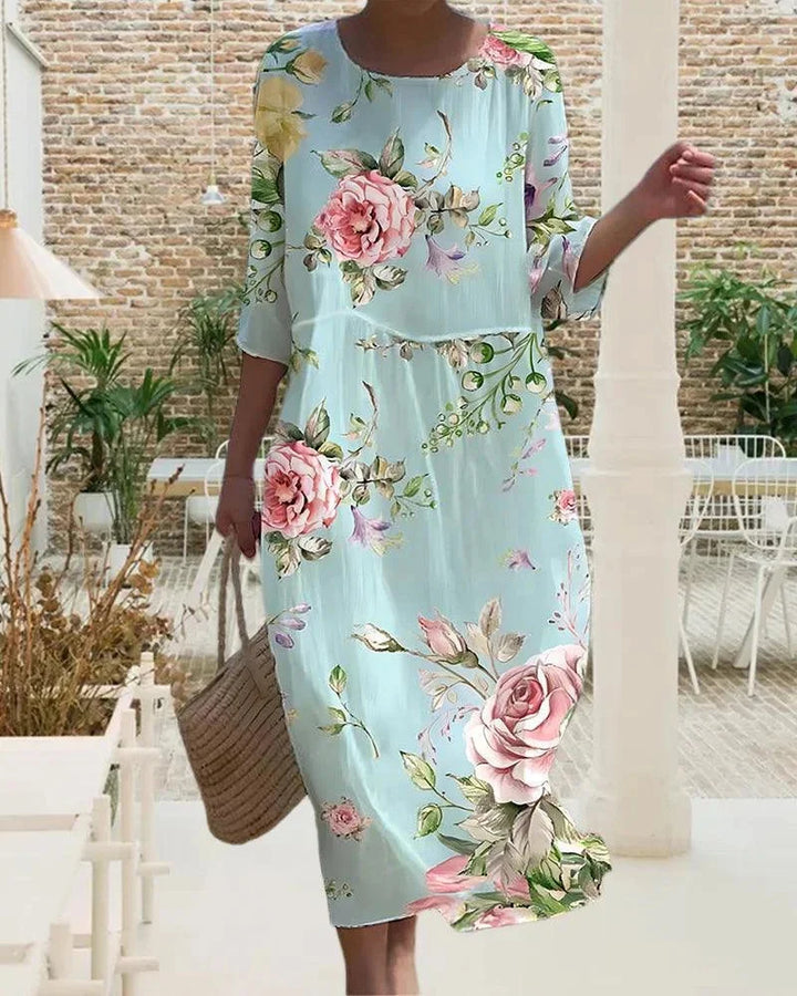 Floral beach dress with sleeves in a midi length, perfect for sunny days by the coast in flowy and breathable fabric.