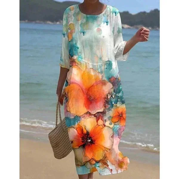 "Sleeved midi beach dress in Flowers design with a floral pattern, perfect for sunny days by the water."