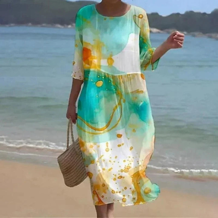 Green floral beach dress with sleeves, perfect for sunny days. Breathable fabric with a flowy midi design for a stylish…