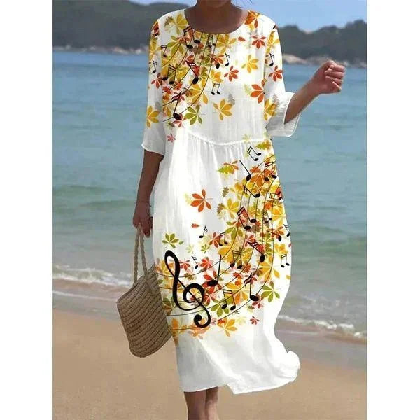 Floral midi beach dress with leaves pattern. Features sleeves and midi length perfect for a beach day.