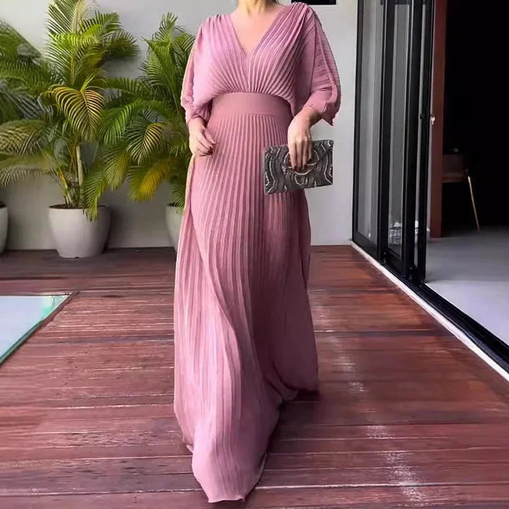 Dusty pink pleated maxi dress with V-neckline, designed for elegance and comfort.