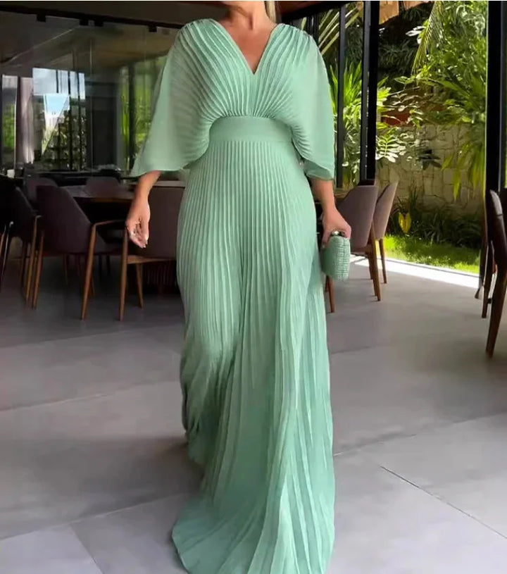 Mint pleated maxi dress with V-neckline, featuring airy fabric and elegant design perfect for any occasion.