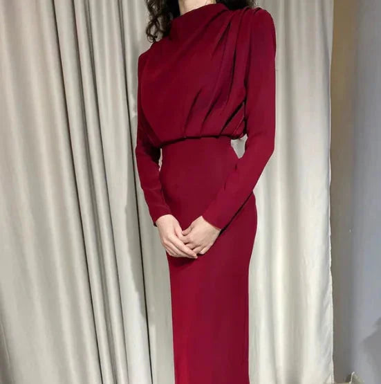 "Brick red long-sleeve midi dress with draped back, soft and flowing fabric, perfect for a sophisticated and elegant look."