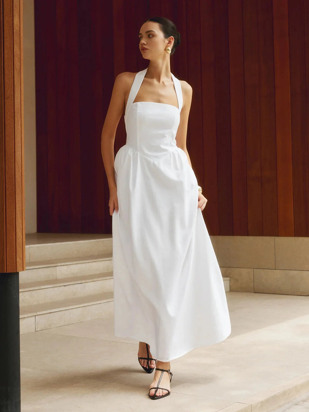 White sleeveless maxi dress with A-line silhouette and subtle textured pattern, perfect for a daytime event or casual outing.