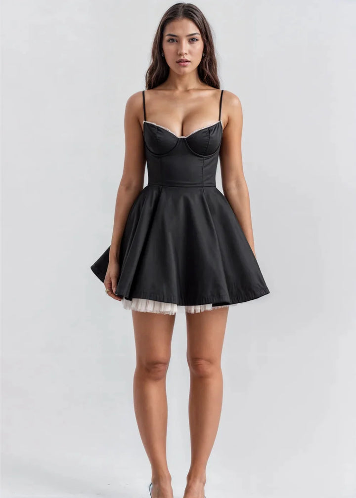 Black flared mini dress with delicate straps made of lightweight chiffon fabric, perfect for a chic and elegant look.