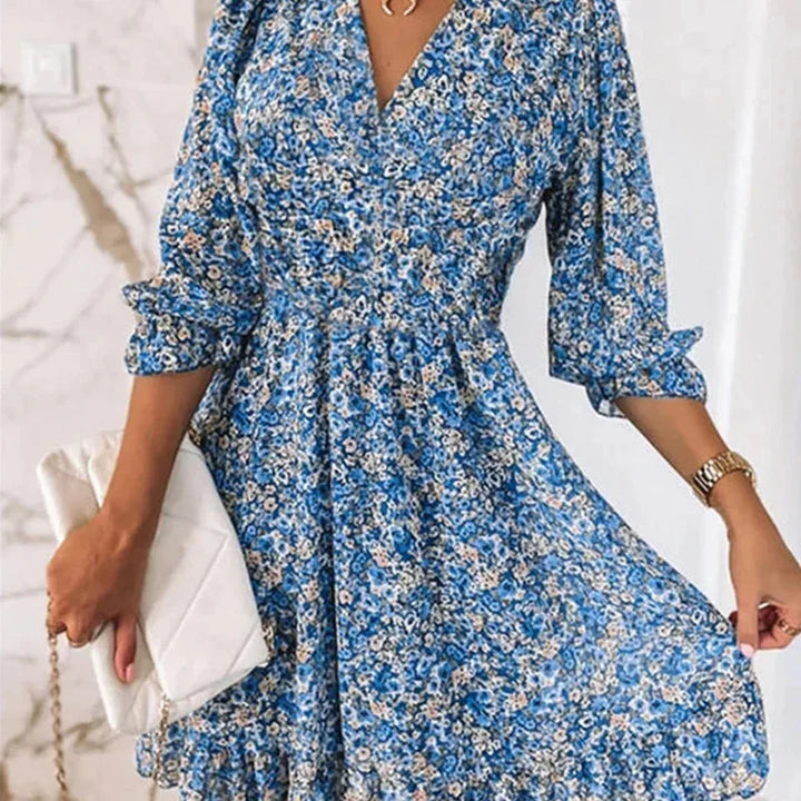 Blue floral Boho dress with a flattering V-neckline, made from soft and flowy fabric. Perfect for a casual yet stylish look.