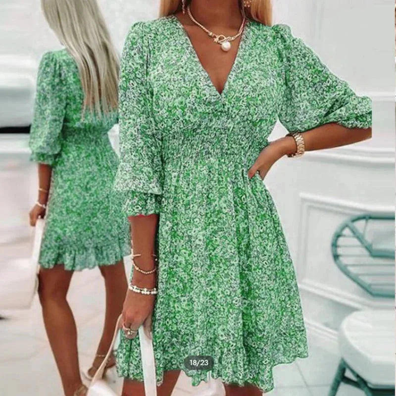 Green v-neckline floral Boho dress by Maddy. Made from soft cotton with a relaxed silhouette and intricate floral pattern.