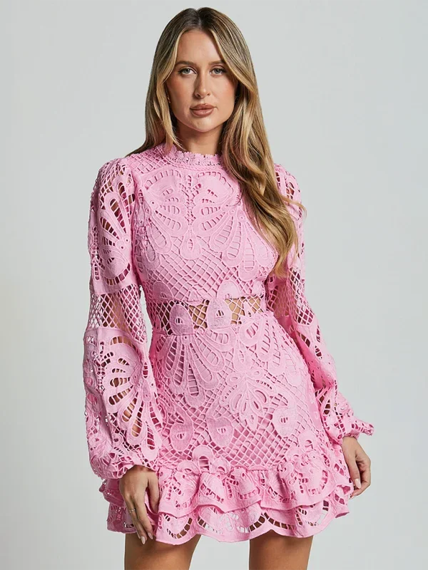 Pink lace mini dress with ruffled detailing and long sleeves. Feminine and elegant, perfect for a special occasion.