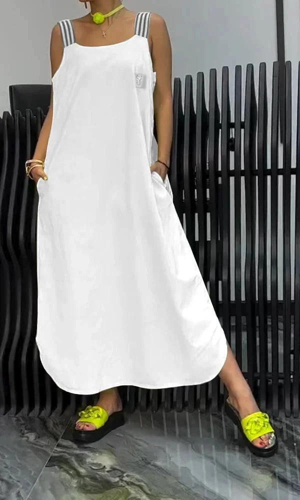 "Sleeveless maxi dress in flowy cotton blend with convenient pockets, ideal for all-day comfort and style."