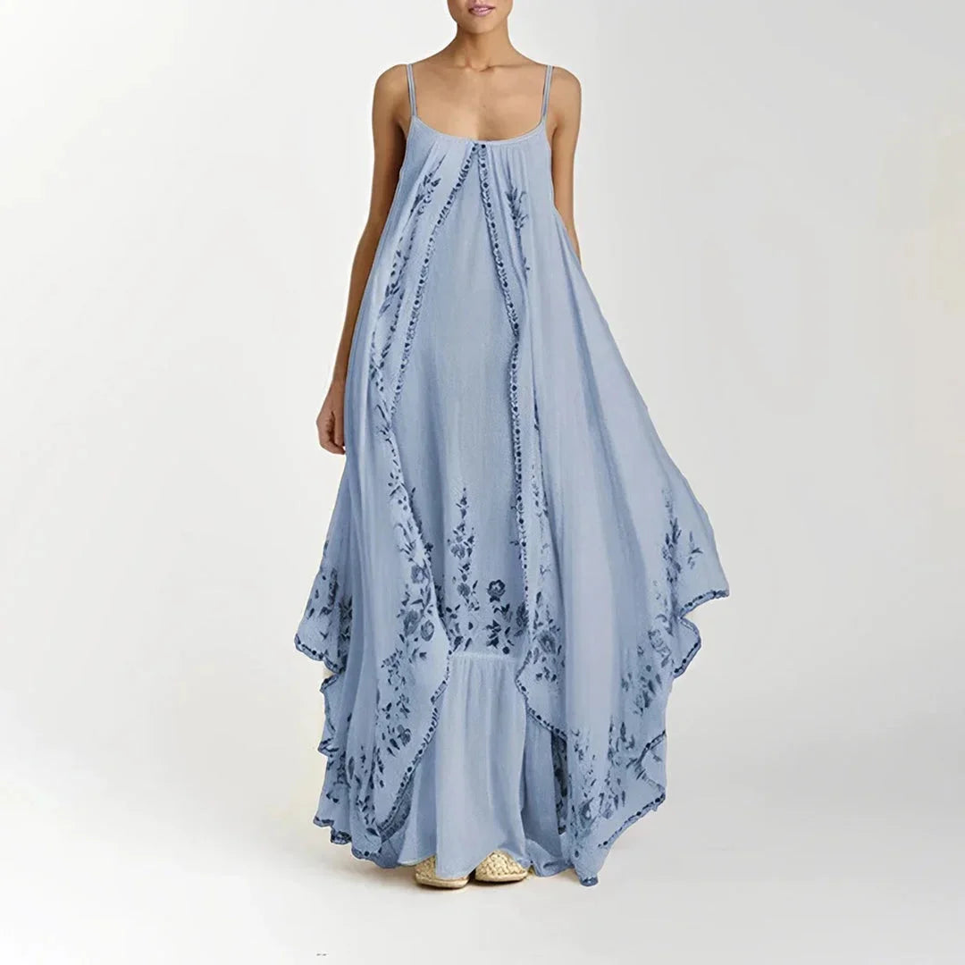 Blue spaghetti strap floral maxi dress made from lightweight chiffon with a flowing silhouette perfect for summer outings or…