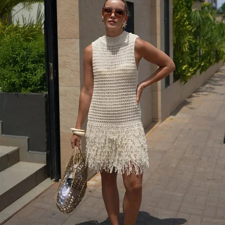 Ivory sleeveless dress with tassels, clean lines, round neck, and comfortable fabric.