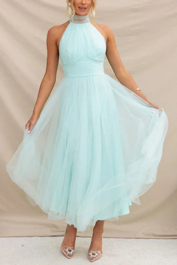 Light blue pleated midi dress with a halter neck design by Marisela. Made from soft and flowy fabric, perfect for both…