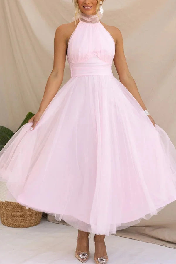 Pink halter neck midi dress with elegant pleats, perfect for stylish events.