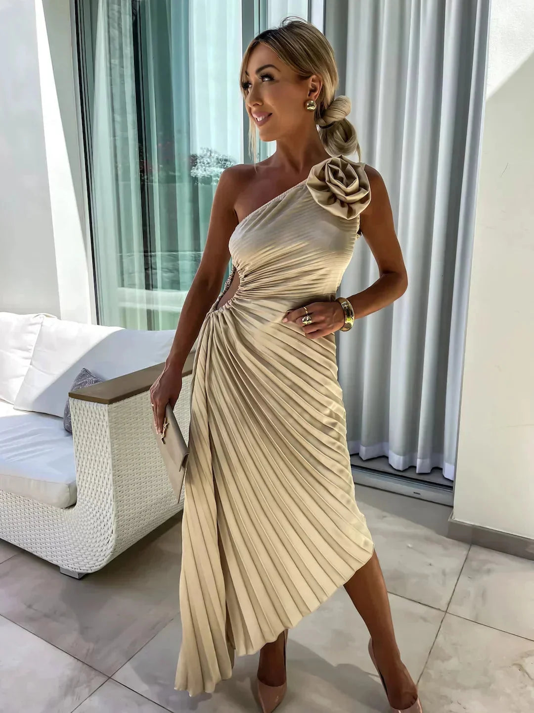 Beige pleated midi dress with one-shoulder design, perfect for elegant occasions and events.