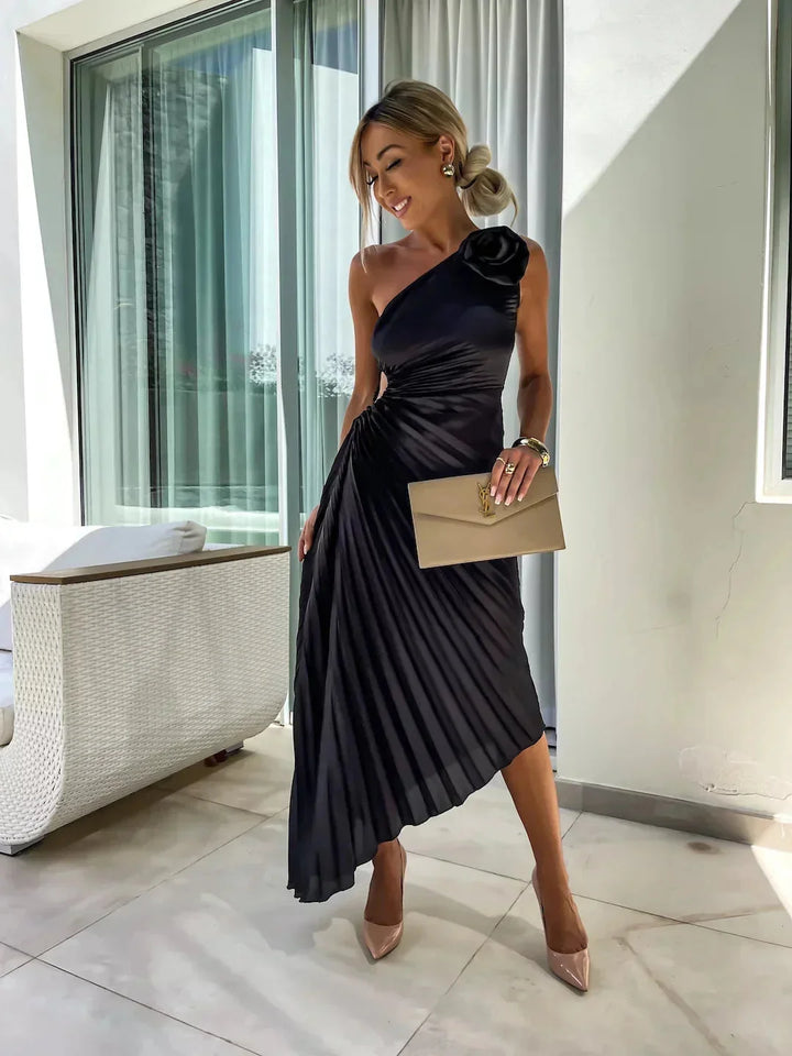 Black Marlowe one-shoulder pleated midi dress with a modern asymmetrical design and flowy silhouette, perfect for any…