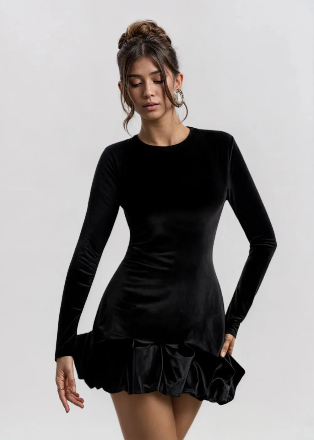 Black velvet dress with flared ruffle hem, sophisticated and elegant design for a touch of glamour.