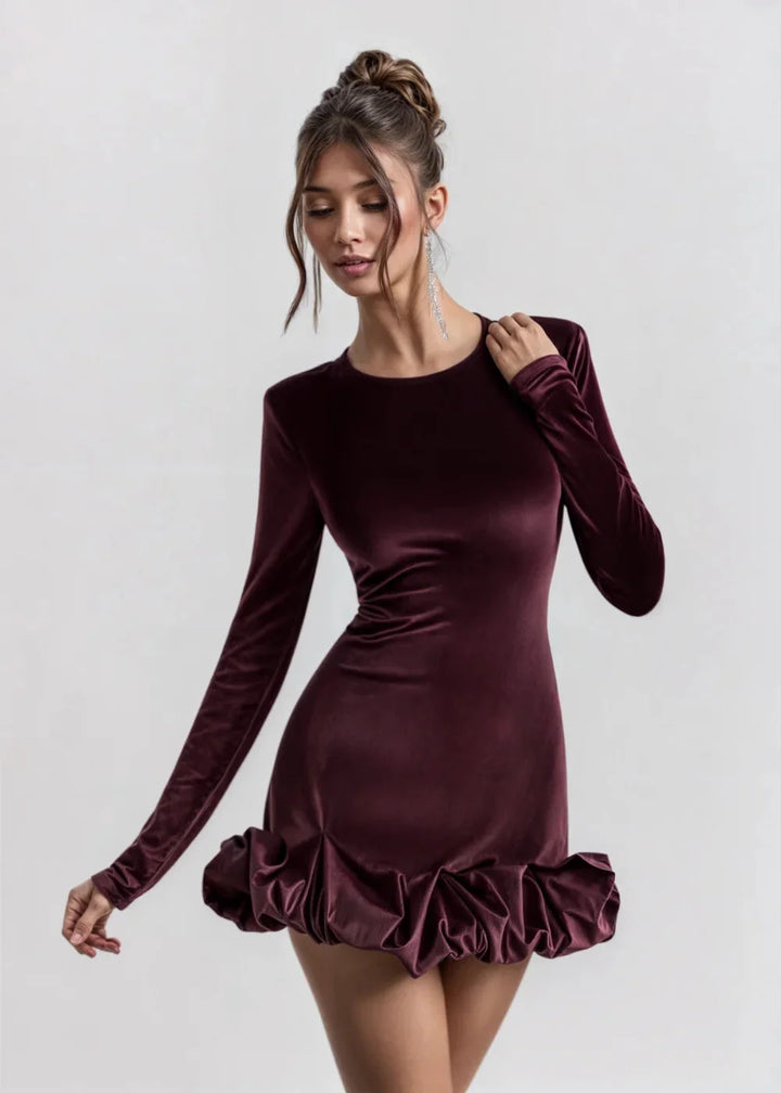 Burgundy velvet dress with flared ruffle hem, a stylish and elegant choice for special occasions or evening events.