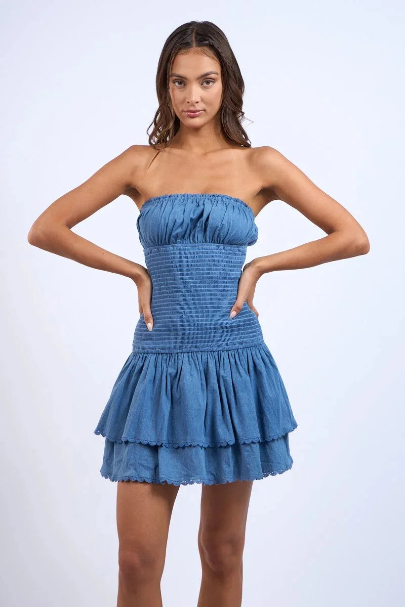 Strapless mini dress in Denim blue, smocked tiered design. With a comfortable fit and casual look for any occasion.