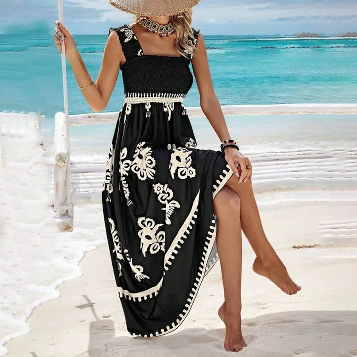 Black strapless maxi dress with a bohemian print in soft and flowy fabric, perfect for a relaxed and stylish summer look.