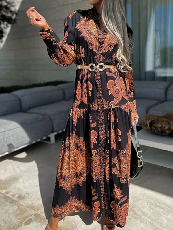 Black maxi dress with elegant high slit in paisley print. Made of flowy fabric, perfect for formal events or a night out.