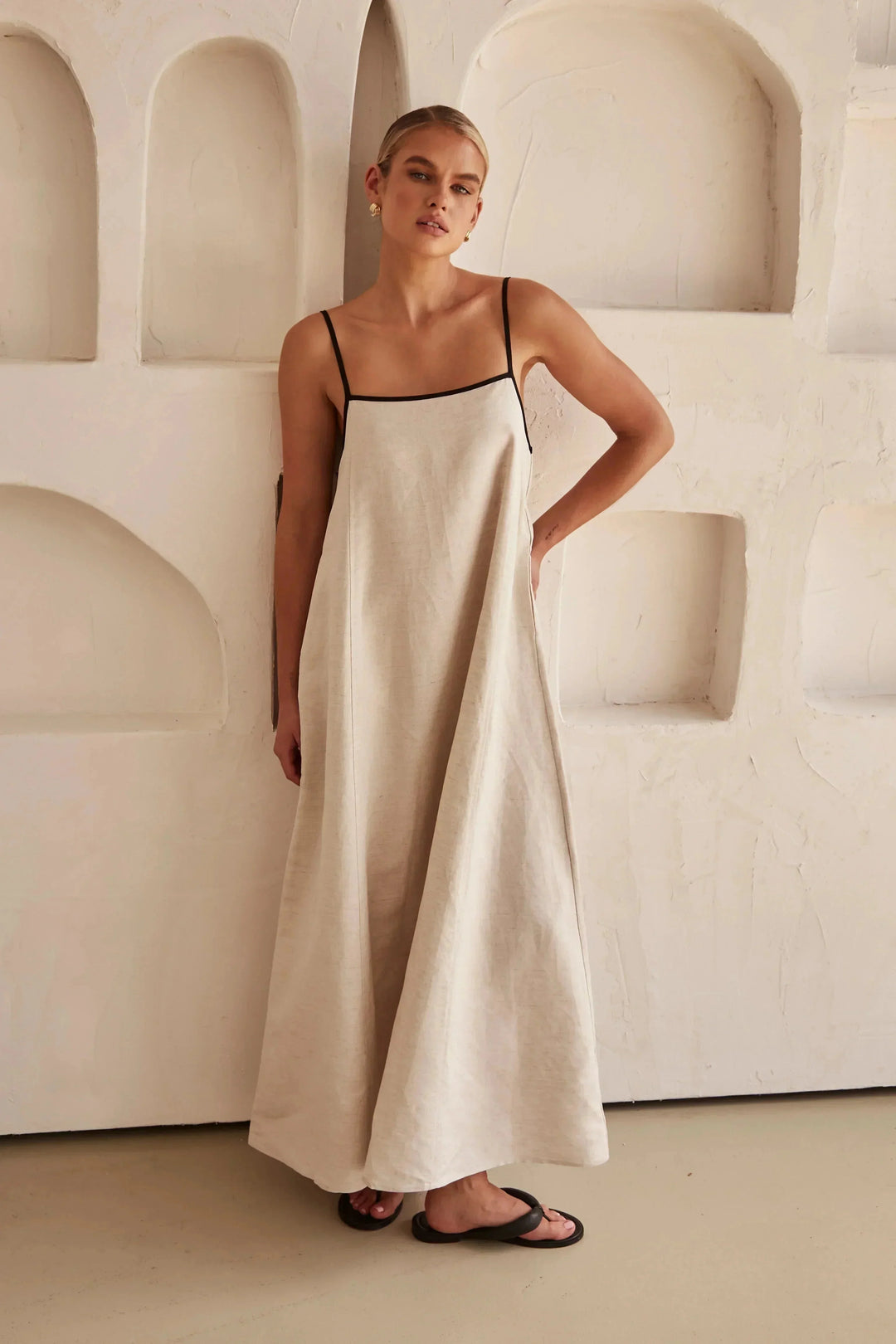 Alt text: "Beige linen maxi dress with black trim, a stylish and versatile wardrobe staple for everyday wear or special…