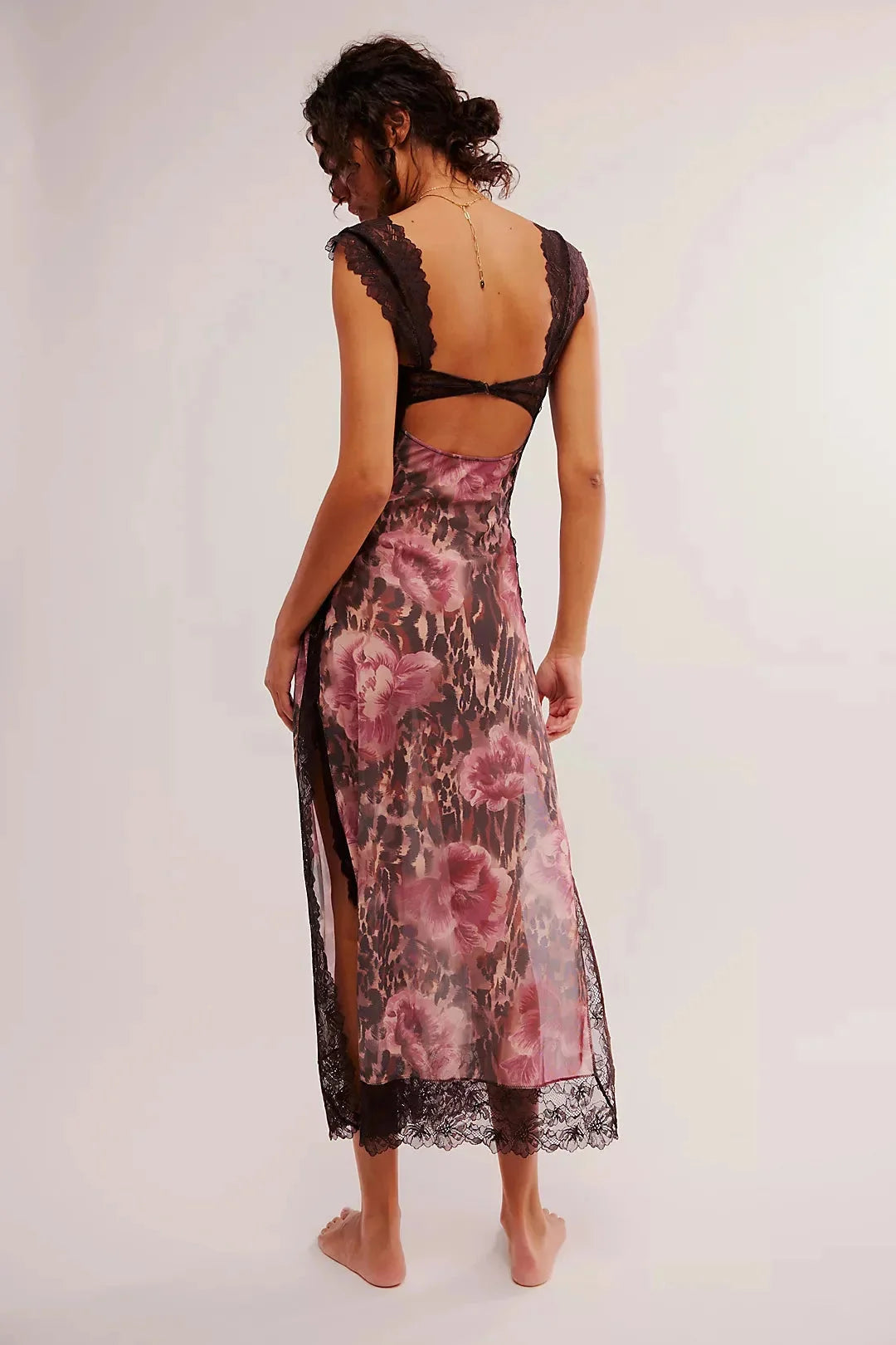 A sheer maxi dress with a vibrant floral print, perfect for a breezy summer day.