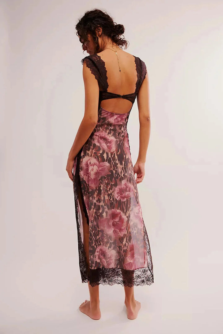 A sheer maxi dress with a vibrant floral print, perfect for a breezy summer day.