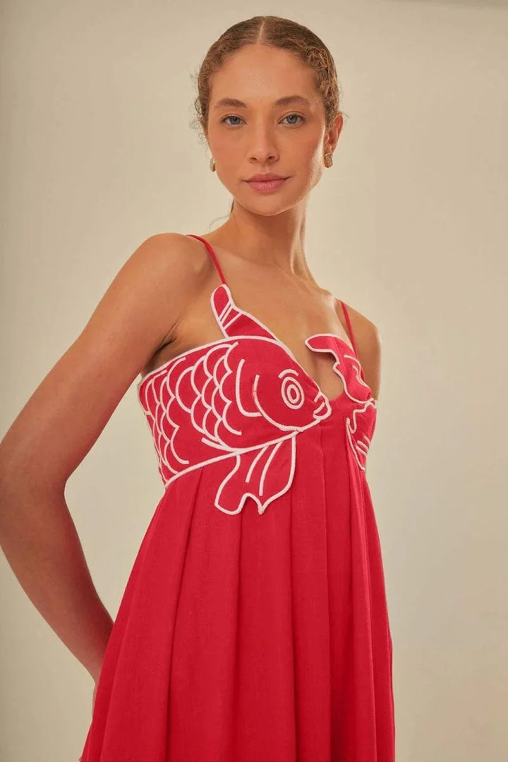 Red sleeveless maxi dress with intricate white embroidery on the bodice for a modest yet stylish look, perfect for any…