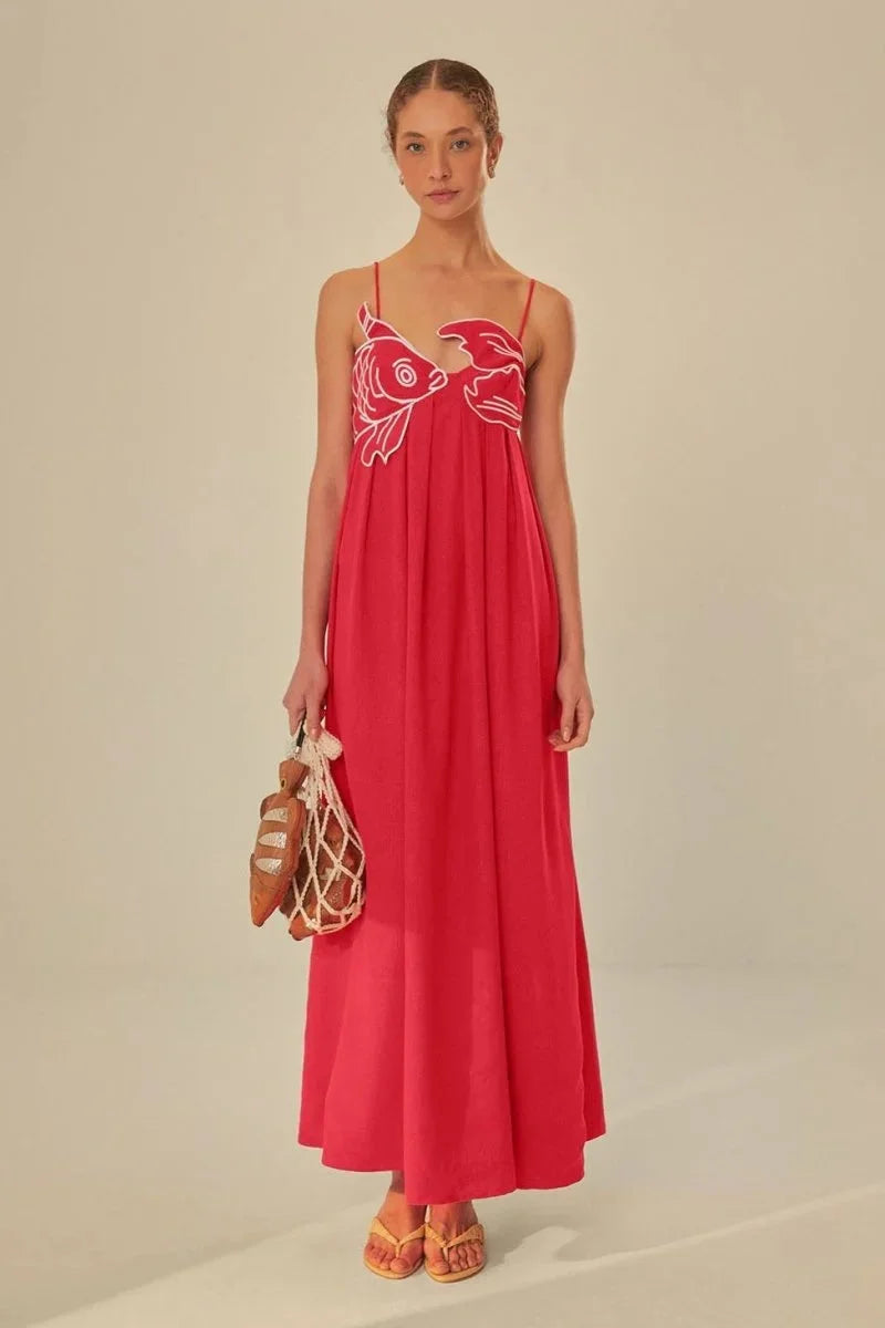 Red sleeveless maxi dress with intricate embroidery detailing, perfect for modest fashion lovers.