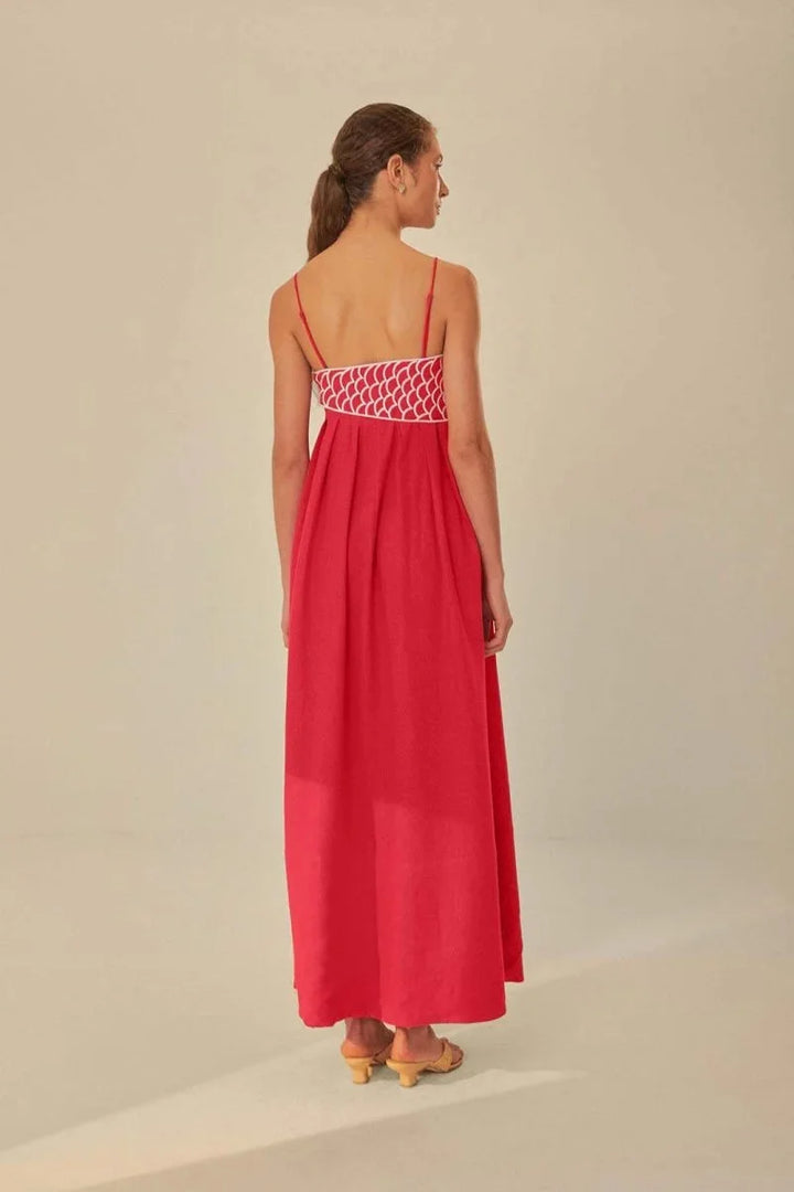 Red sleeveless maxi dress with intricate embroidery detailing on the bodice and hem. Crafted from breathable and lightweight…