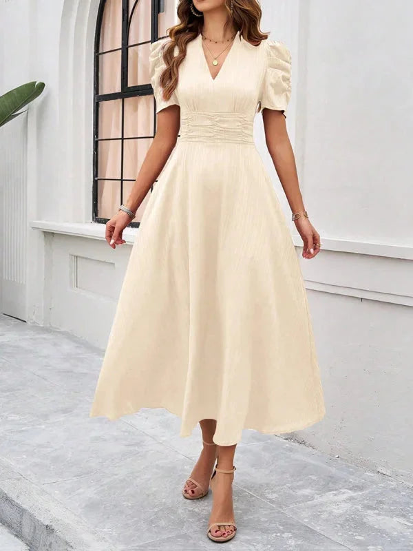 "V-neck midi dress with puff sleeves, made from flowy fabric in a chic design."