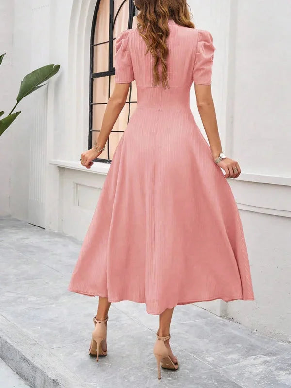 Flowy midi dress with puff sleeves and V-neck in a soft and breathable fabric. Classic and stylish addition to your wardrobe.