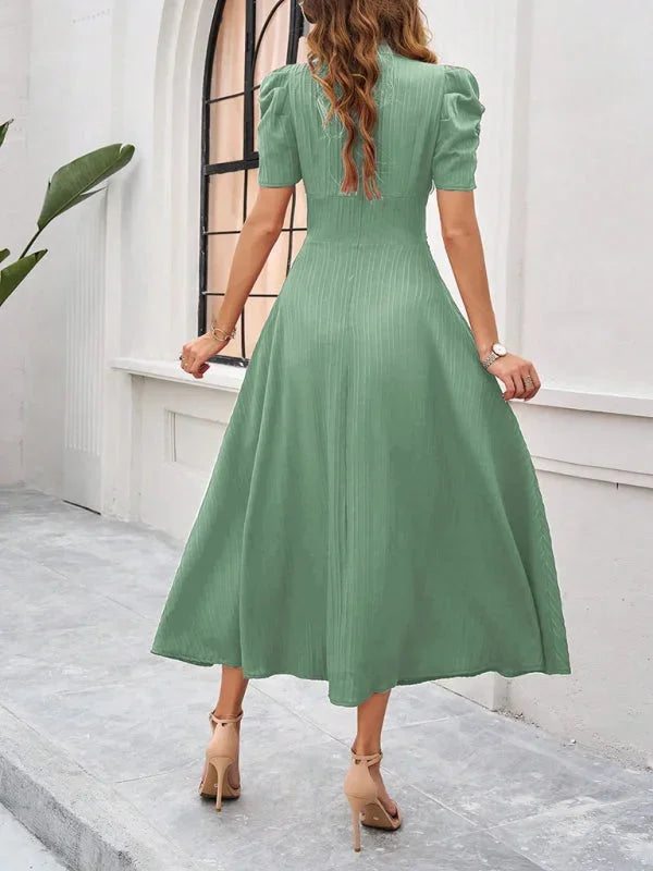 V-neck midi dress featuring puff sleeves and a flowy design in a soft and breathable fabric.