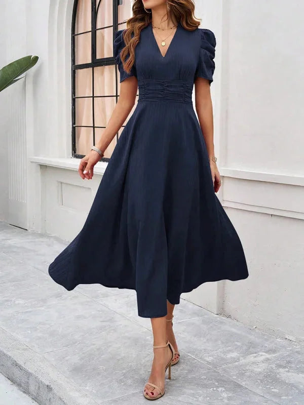 Flowy midi dress with puff sleeves, designed with a flattering V-neck. Made from lightweight fabric perfect for everyday…