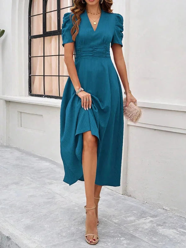 V-neck midi dress with puff sleeves, made of flowy fabric in a loose fit.