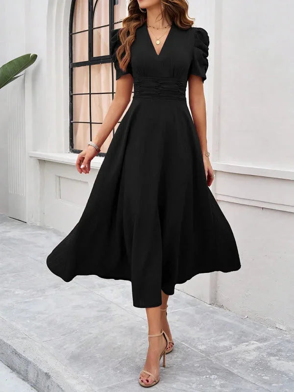 V-neck flowy midi dress in soft fabric with puff sleeves, perfect for a chic and effortless look.