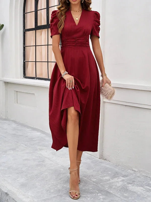 "Puff sleeve V-neck midi dress in flowy fabric, ideal for casual outings or evening events."