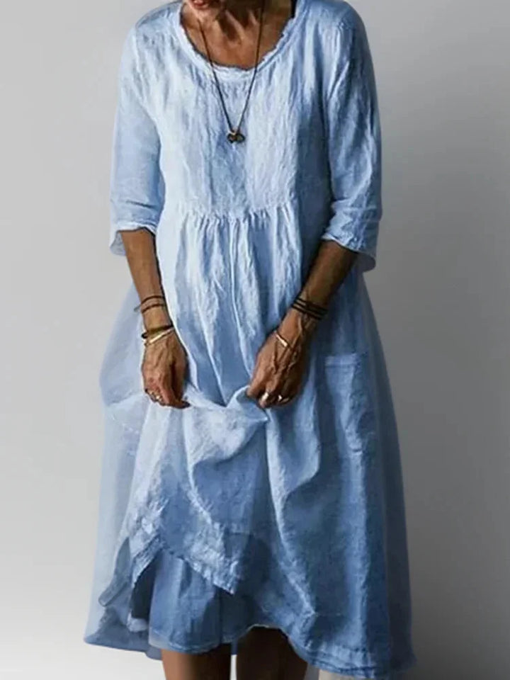 "Nell - V-neck tiered maxi dress with 3/4 sleeves in soft cotton blend, featuring a relaxed fit and stylish design."