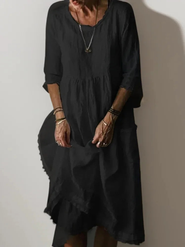 "Black V-neck tiered maxi dress with 3/4 sleeves made from flowy and lightweight fabric, perfect for casual or formal…