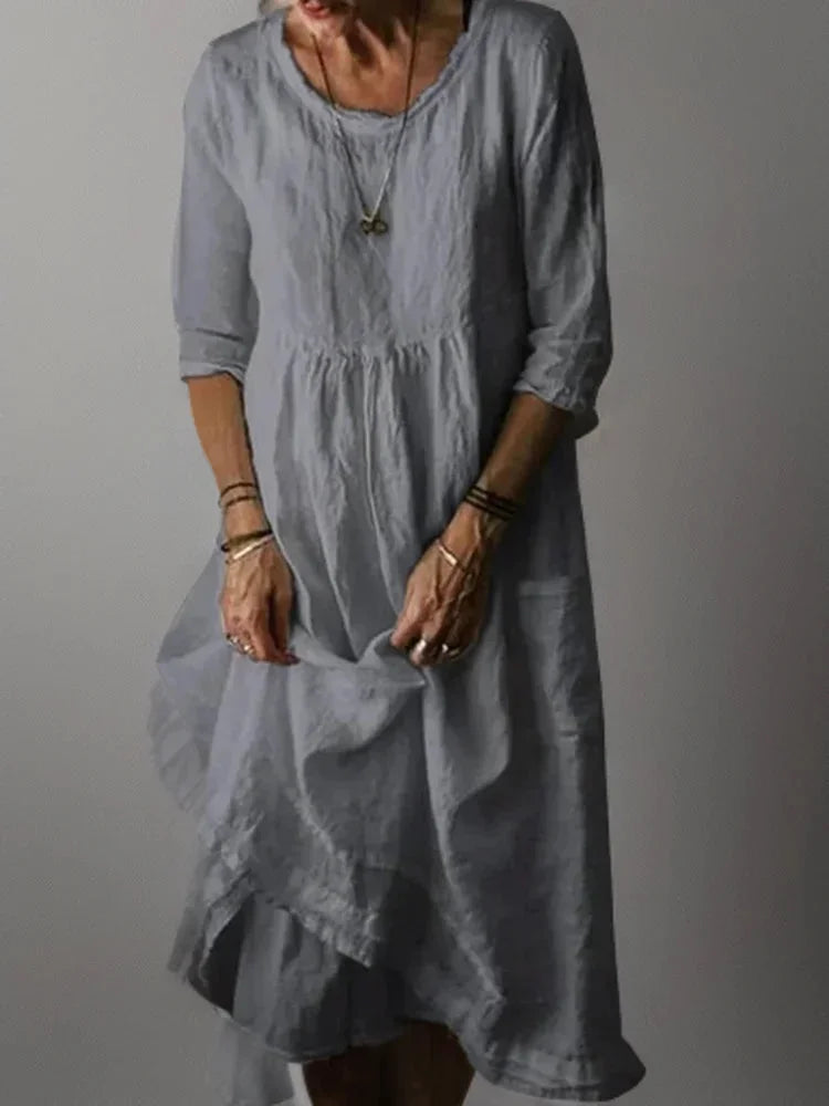 "Grey V-neck tiered maxi dress with 3/4 sleeves, flowy and comfortable design for casual or formal occasions."