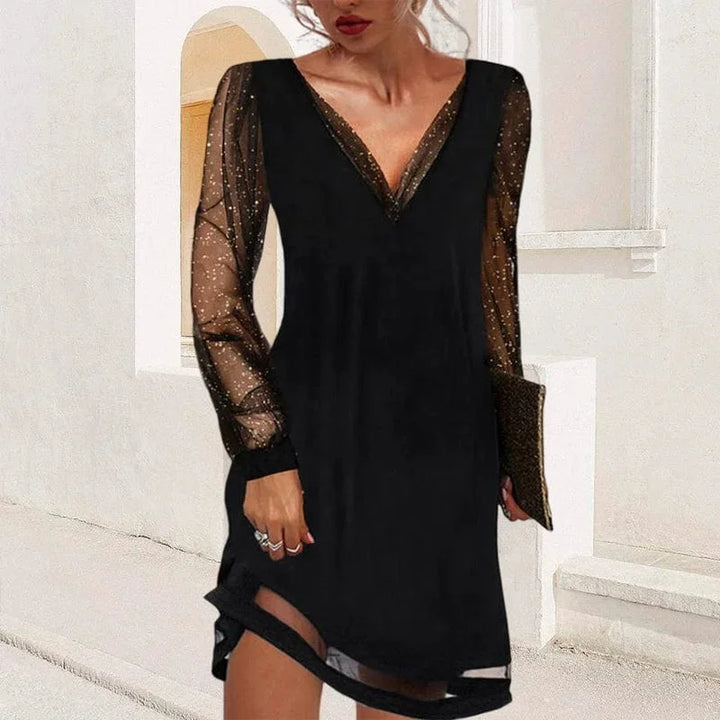 "Nico V-neck mini dress features sheer sleeves and a figure-flattering silhouette, perfect for making a chic statement."