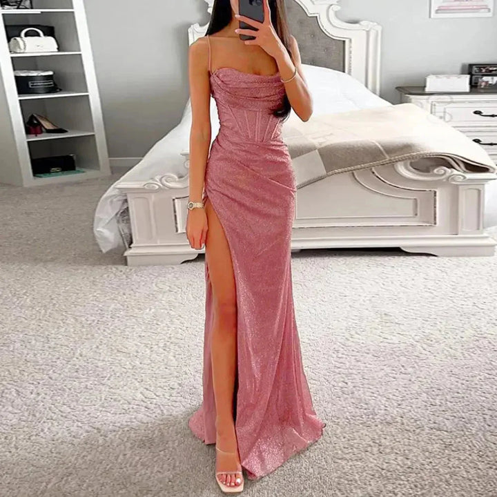 Pink strapless dress with high slit; made from flowy fabric, accentuates elegance and style without compromising comfort.