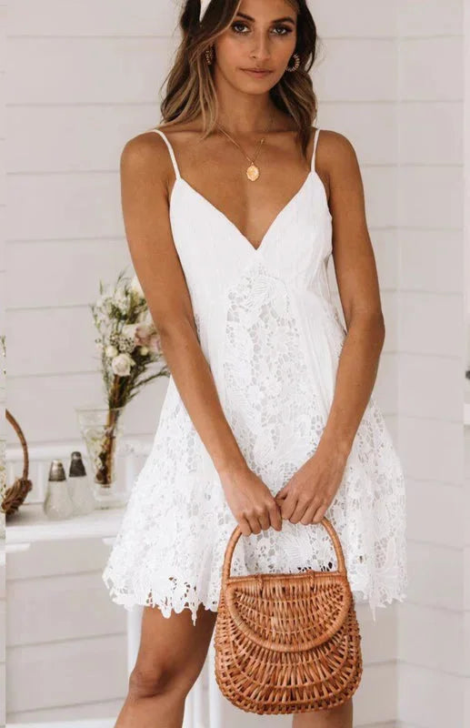 White lace spaghetti strap mini dress with a flattering v-neck design, perfect for a chic and elegant look.