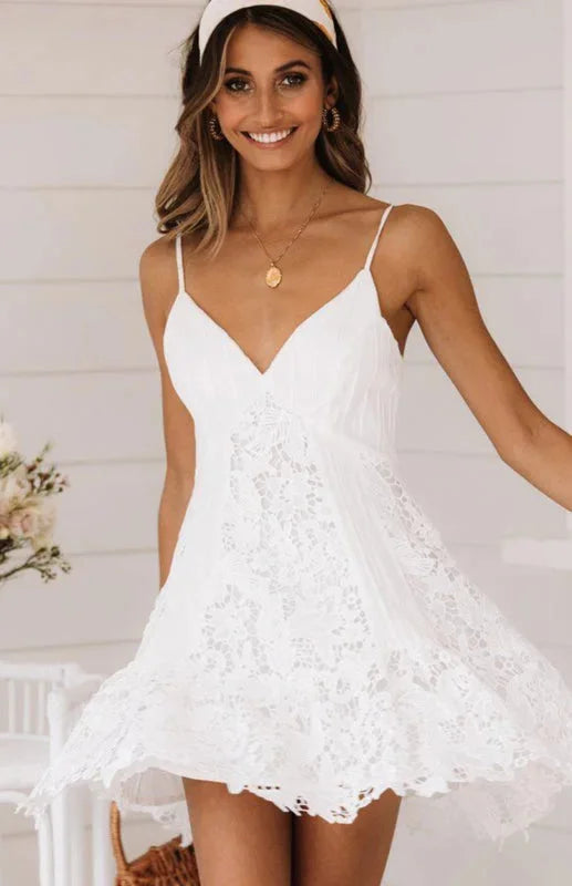 White lace v-neck mini dress with spaghetti straps, perfect for summer events.