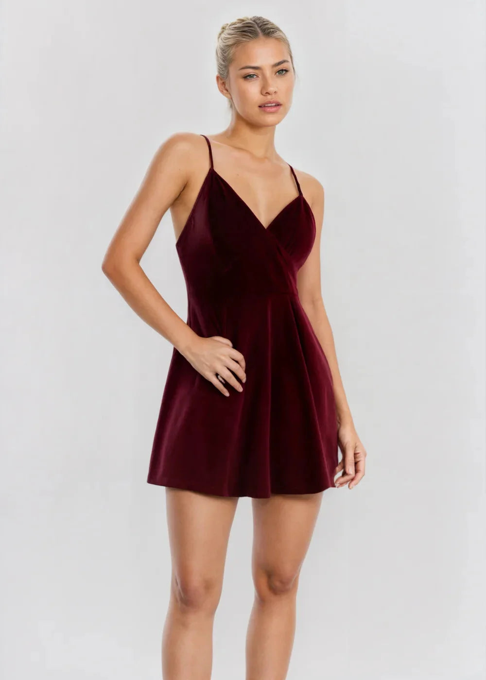 Burgundy velvet skater dress with a V-neck, showcasing a rich, soft texture - the perfect blend of elegance and comfort.