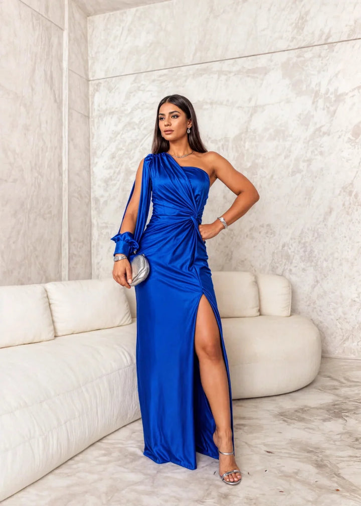 Navy satin dress featuring unique gathered detail on the front. Flattering fit and ideal for special occasions or evening…