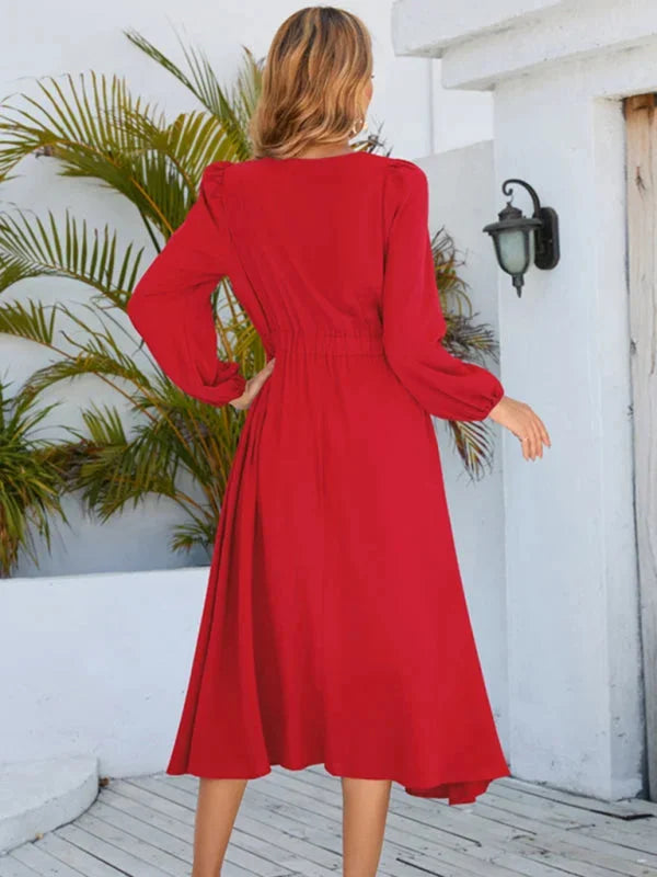 Navy blue knee-length dress with flowy silhouette, bow accent on the waist.